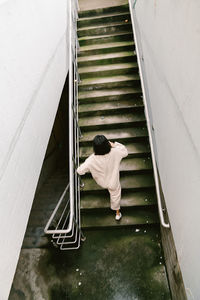 High angle view of man sitting on stairs