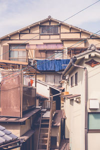 Low angle view of buildings in town against sky