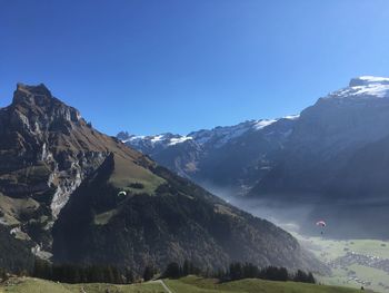 Scenic view of snowcapped mountains against clear sky