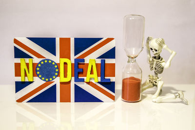 Close-up of glasses on table against white background