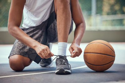 Midsection of man playing basketball