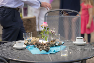 After the party - flowers decoration with used glasses and plates stands on a patio table