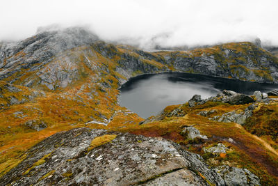 Scenic view from mountain summit of lake and cloudy sky at munkebu in moskenesoya lofoten norway