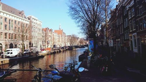 Canal along buildings in city