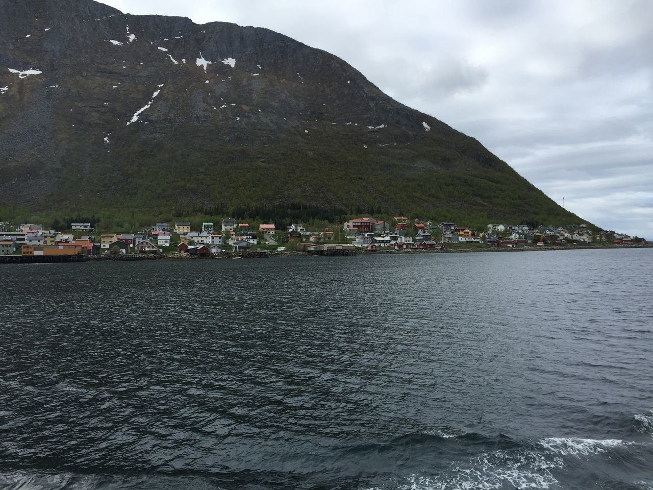 mountain, water, sky, sea, waterfront, building exterior, scenics, mountain range, built structure, tranquil scene, architecture, tranquility, beauty in nature, nature, house, rippled, cloud - sky, town, lake, tree