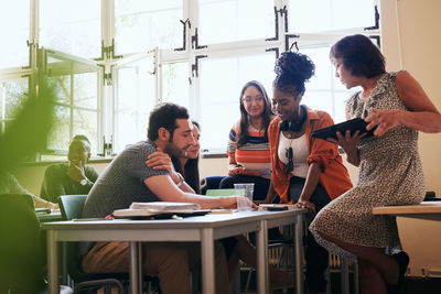 Multi-ethnic students with teacher in language school