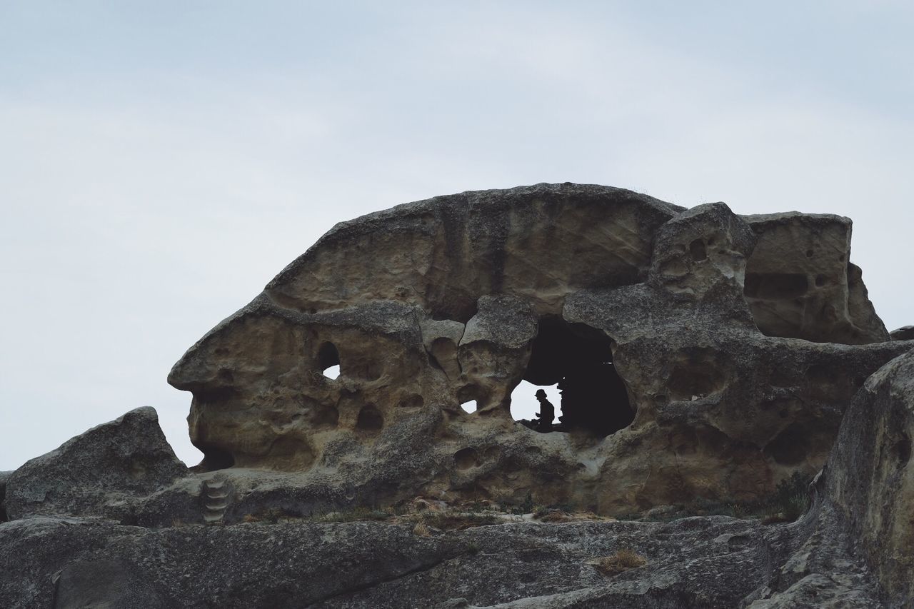 LOW ANGLE VIEW OF ROCK FORMATIONS AGAINST SKY