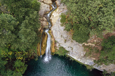 Waterfall and lagoon in the middle of the forest