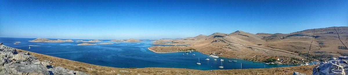 Panoramic view of landscape against clear blue sky