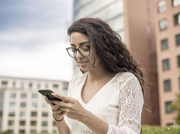 Midsection of woman using mobile phone