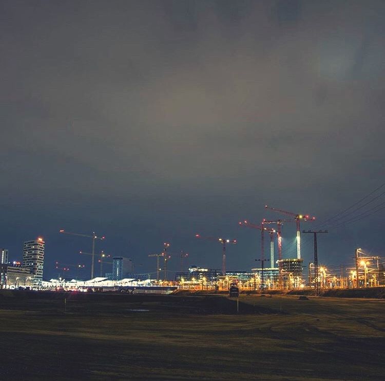 ILLUMINATED FACTORY AGAINST SKY AT NIGHT IN CITY