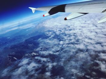 Airplane flying over sea against sky