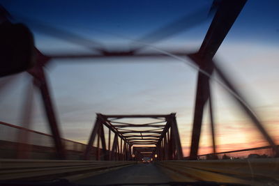 Suspension bridge against sky during sunset