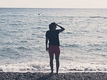 Rear view of man standing on beach