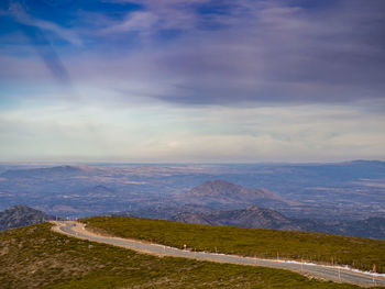 Scenic view of mountains against cloudy sky