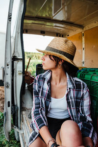 Woman looking away while sitting in car