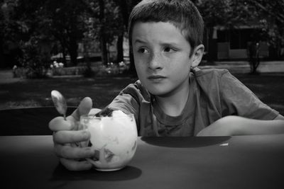 Portrait of boy sitting on table