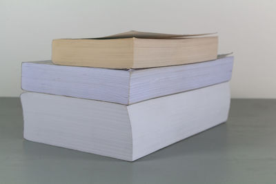 Close-up of books on table against white background