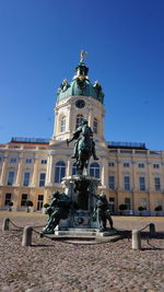 Low angle view of statue against building