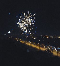 Low angle view of firework display at night