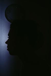 Close-up of silhouette man against dark background