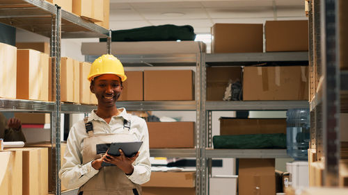 Portrait of young man working in factory