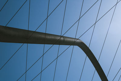 Low angle view of suspension bridge against sky