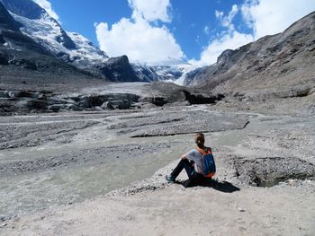 Woman sitting with mountain in background