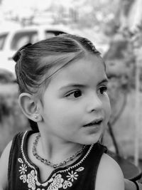 Close-up of thoughtful girl sitting outdoors