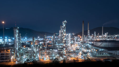 Of chemical industry storage tank and oil refinery in industrial plant at night over lighting, 