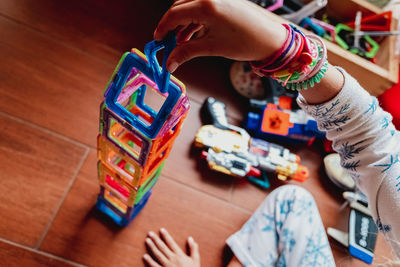 High angle view of child playing with toy on table