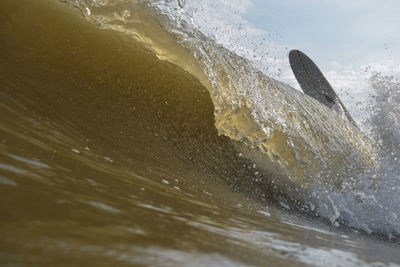 Close-up of sea waves splashing on beach