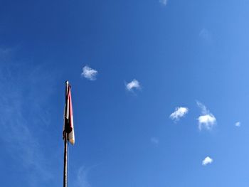 Low angle view of flags hanging against sky