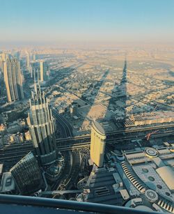 High angle view of city buildings against clear sky