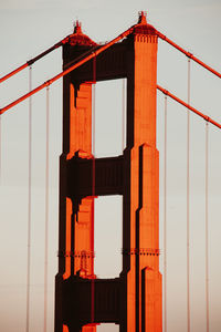 Low angle view of suspension bridge against sky during sunset