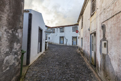 Narrow alley amidst buildings in city