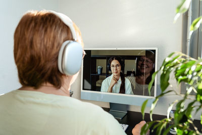 Senior adult plus size woman having online psychotherapy session with  psychologist  at home