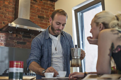 Young couple preparing coffee