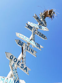 Low angle view of sign against blue sky