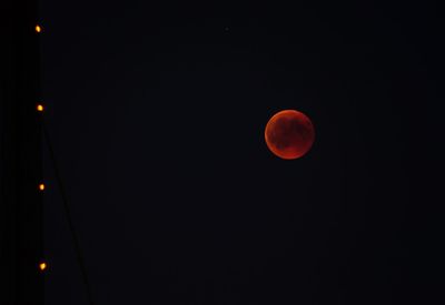 Low angle view of moon against sky at night