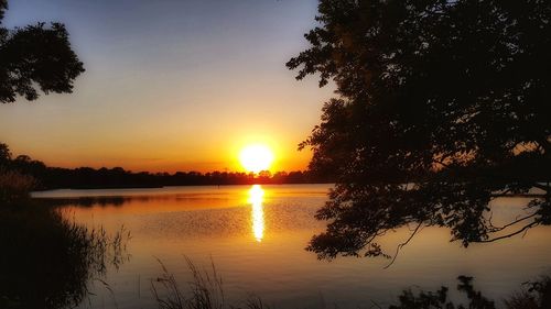 Scenic view of lake against sky during sunset