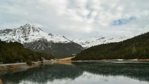 Scenic view of lake against cloudy sky