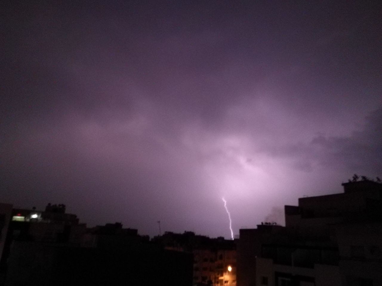 sky, night, built structure, architecture, building exterior, nature, no people, low angle view, silhouette, illuminated, outdoors, city, beauty in nature, lightning, thunderstorm, astronomy, star - space, forked lightning