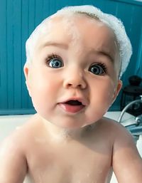 Close-up portrait of cute baby girl in bathroom