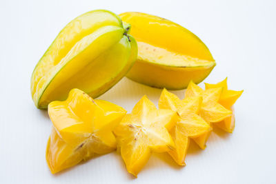 High angle view of yellow fruit against white background