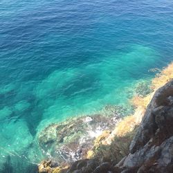 High angle view of rocks on sea