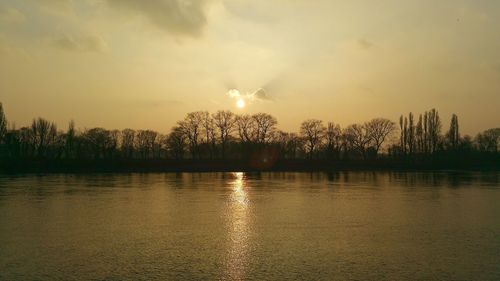 Scenic view of lake against sky at sunset