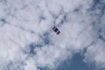 Low angle view of paragliding against sky