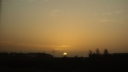 Silhouette trees against sky during sunset