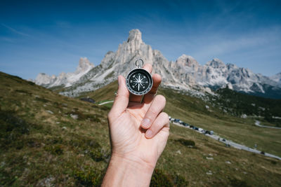 Human hand holding mountain